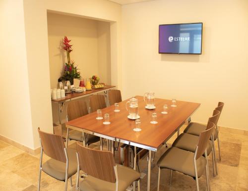 a conference room with a wooden table and chairs at Hotel Estelar San Isidro in Lima