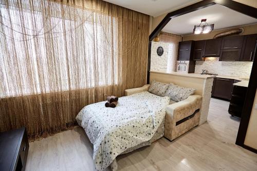 a bedroom with a bed with a teddy bear on it at Babylon Apartments on Vidinska in Rivne