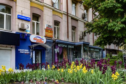 a bunch of flowers in front of a building at 7 Sky on Shchorsa Street in Kyiv