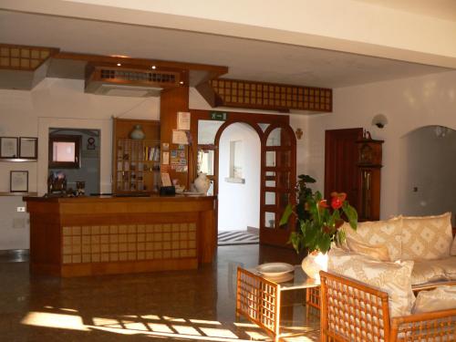 a living room with a couch and a table at Hotel Il Piccolo Golf in Porto Cervo