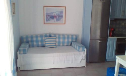 a couch in a living room with a refrigerator at Glyfada Corfu Apartment in Glyfada