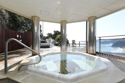 a bath tub sitting on top of a house at Shimoda Yamatokan in Shimoda