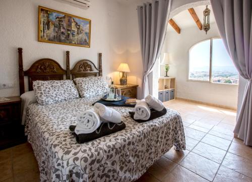 En eller flere senge i et værelse på Bella Vista by Aguilarent