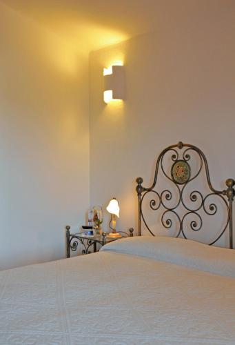 a bedroom with a bed with a white bedspread at Hotel Il Piccolo Golf in Porto Cervo