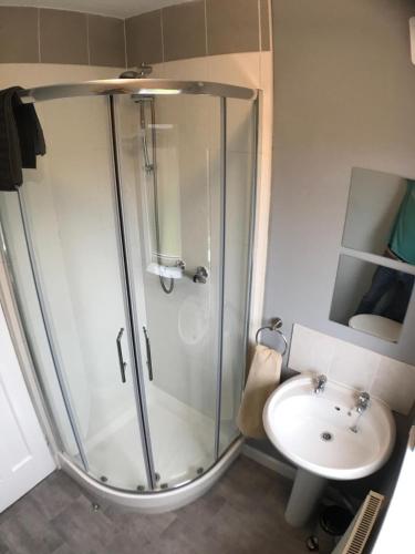 a bathroom with a shower and a sink at Wyken House - 3 Bedroom House Coventry - Sleeps 5 in Coventry