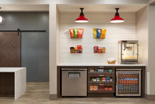 a kitchen with a counter with a drink cooler at Canalta Airdrie in Airdrie