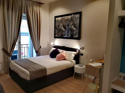 a bedroom with a large bed and a window at Grande Archivio Napoli 22 in Naples