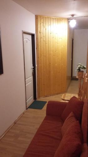 a living room with a couch and a door at Penzion Dalibor in Trutnov