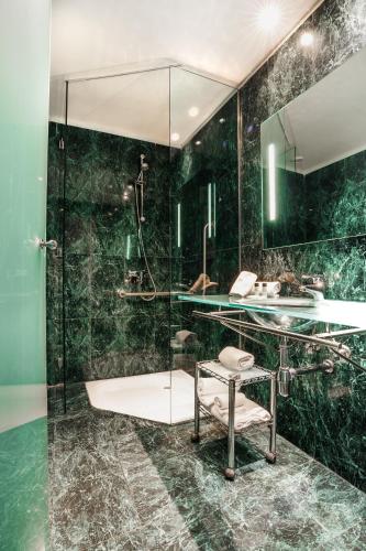 a bathroom with a glass shower and a sink at Max Hotel Livorno in Livorno
