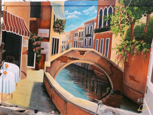 a painting of a bridge over a canal at Peaceful House Hostel in Dong Hoi