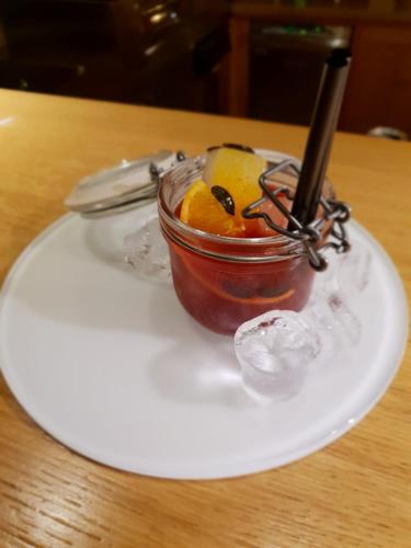 a glass jar of sauce on a white plate at Sport Hotel Alpina in Madesimo