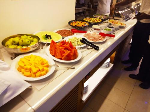 a buffet line with many different types of food at Monty Suites & Golf in Uyo