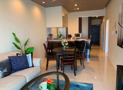 a living room with a couch and a dining room at Ocean Resort House 205 in Onna