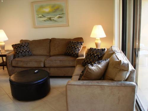 a living room with a couch and a stool at Midnight Cove #532, Bayside in Siesta Key, FL in Siesta Key