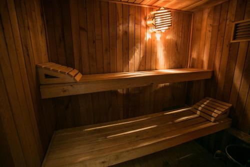 a sauna with a bench in a wooden wall at Cabañas Hosteria de Vilches in Vilches