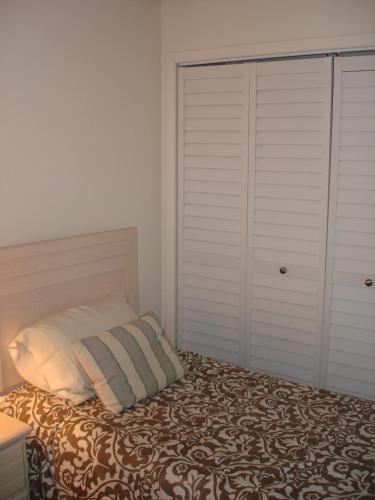 a bedroom with a bed and a closet at Midnight Cove #532, Bayside in Siesta Key, FL in Siesta Key