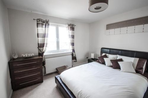 Un dormitorio con una cama grande y una ventana en City Centre Orange Apartments - Portland Street, en Aberdeen