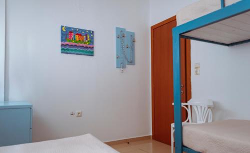 a bedroom with a bunk bed and a bunk bed at Sun Βy Τhe Sea 100m from the beach in Agia Pelagia