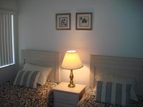 a bedroom with a bed and a lamp on a night stand at Midnight Cove #532, Bayside in Siesta Key, FL in Siesta Key