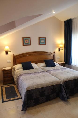 a bedroom with two beds in a room at Apartamentos La Lula in Cudillero
