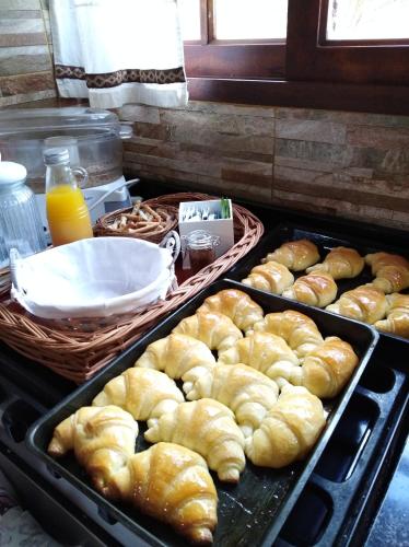 a bunch of pastries in trays on a stove at Cabañas Abigail in Nono