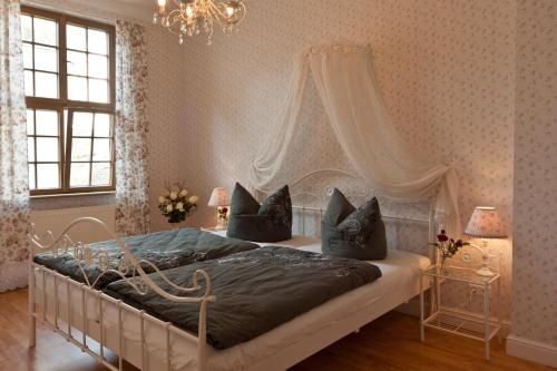 a bedroom with a large bed with a canopy at Apartmenthaus im holländischen Viertel in Potsdam
