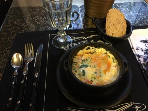 a black plate with a bowl of food on a table at Mama’s Inn Boutique Guest House in Nottingham