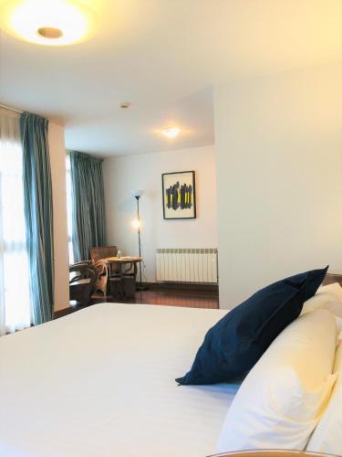 a bedroom with a bed with a pillow on it at Hotel El Sella in Cangas de Onís