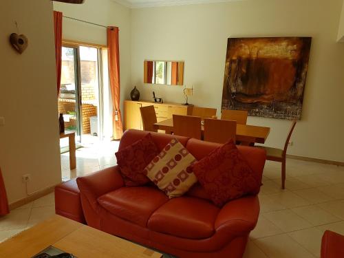 a living room with a couch and a table at Balaia Residence in Albufeira