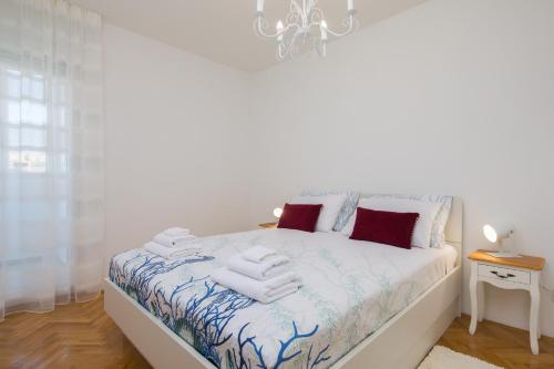 a bedroom with a bed with towels on it at Sidro apartment in Split