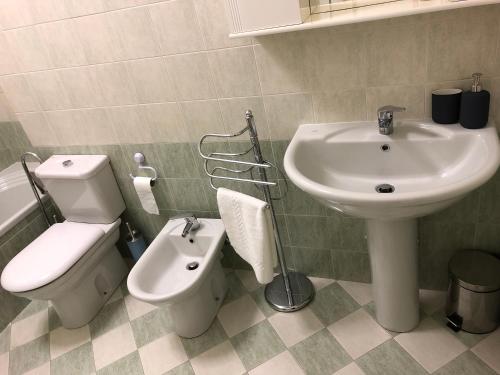 a bathroom with a sink and a toilet and a bidet at "Your Home" Bergamo Centro in Bergamo
