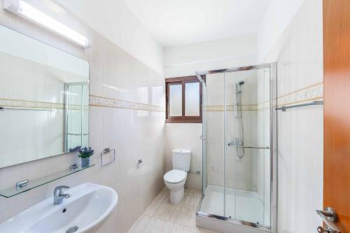 Un baño con ducha, lavabo e inodoro. en Aqua View, en Kissonerga