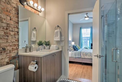 a bathroom with a sink and a shower with a bed at Cityscape 1 - Sleeps 7 in Chattanooga