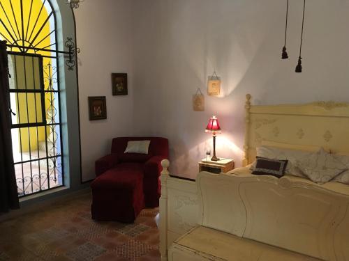 Postel nebo postele na pokoji v ubytování Hacienda San Pedro Nohpat