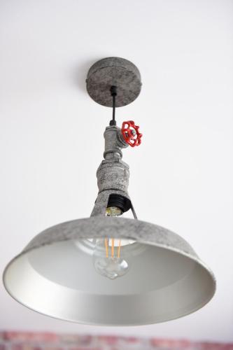 a ceiling light hanging from a ceiling at Best Apartment Suceava in Suceava