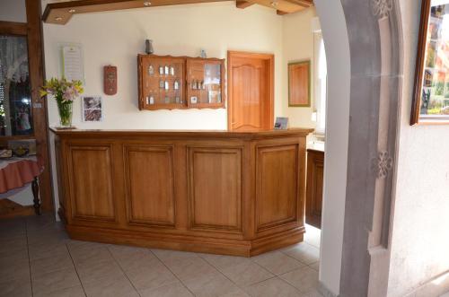 a kitchen with wooden cabinets and a counter top at Relais du Klevener in Heiligenstein