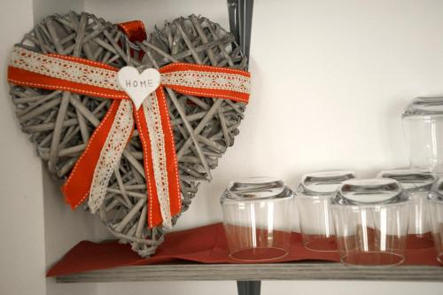 a heart made out of glass jars on a shelf at Hotel Villa Enea in Cattolica