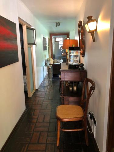 a hallway with a chair and a table in a room at Rent apart Las Condes in Santiago