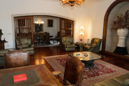 a living room with chairs and a table and a couch at Hotel A Torre do Xudeu in Tui