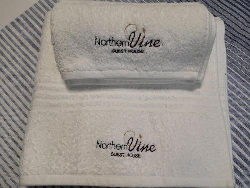 two towels sitting on top of a white towel at Northern Vine Guesthouse B&B Self-catering in Brackenfell