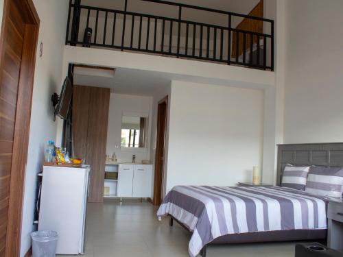 a bedroom with a bed and a loft at Grand Gardenia in Atlixco