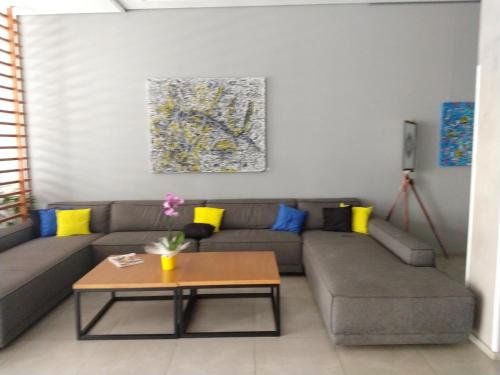 a living room with a couch and a table at Ap 513 Manacás in Itaipava