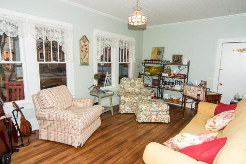 a living room with a couch and two chairs at Wildflower Bed and Breakfast in Mountain View