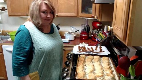 a woman standing in a kitchen in front of an oven at Wildflower Bed and Breakfast in Mountain View