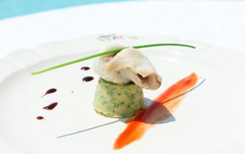 a piece of food on a white plate with carrots at VILLA STEFANIJA small Boutique hotel&restaurant in Barban