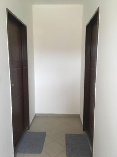 a hallway with two doors and two mats in a room at Garden apartments in Znojmo