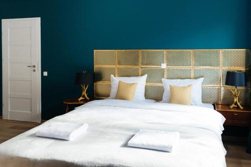 a large white bed with two pillows on it at Villa Lulu Piaseczno in Piaseczno