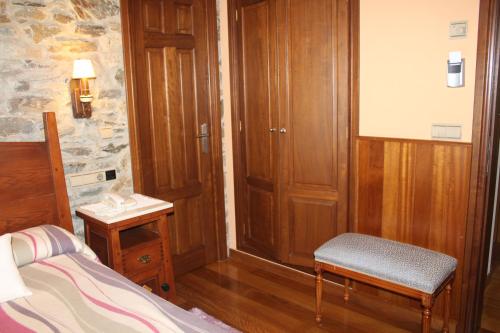 a bedroom with a bed and a table and a chair at Hotel Casa Prendes in Cudillero