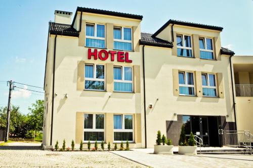 a hotel building with a hotel sign on it at Hotel Sokołowska Airport Modlin in Nowy Dwór Mazowiecki