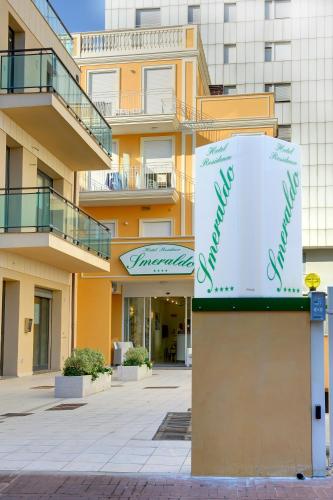 a building with a sign in front of it at Residence Suite Smeraldo in Riccione